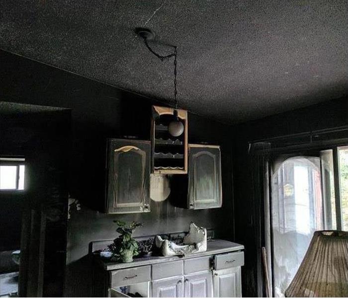 Living room bar cabinets covered in soot and smoke damage