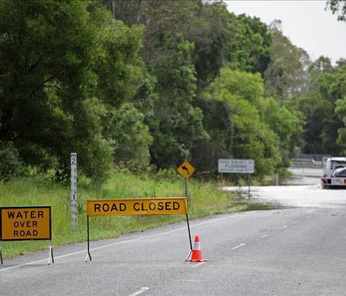flooded country road with "Road Closed" signs